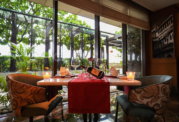 Indoor candlelight dinner at Dilli 32, The Leela Ambience Convention Hotel, Delhi